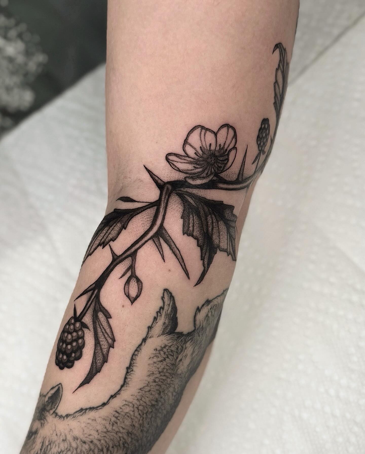 Flower and thorn branch black and grey tattoo on the forearm by jada