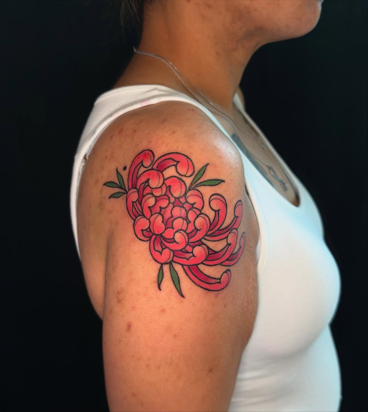 Chrysanthemum American traditional tattoo on the shoulder by Jessica Haug