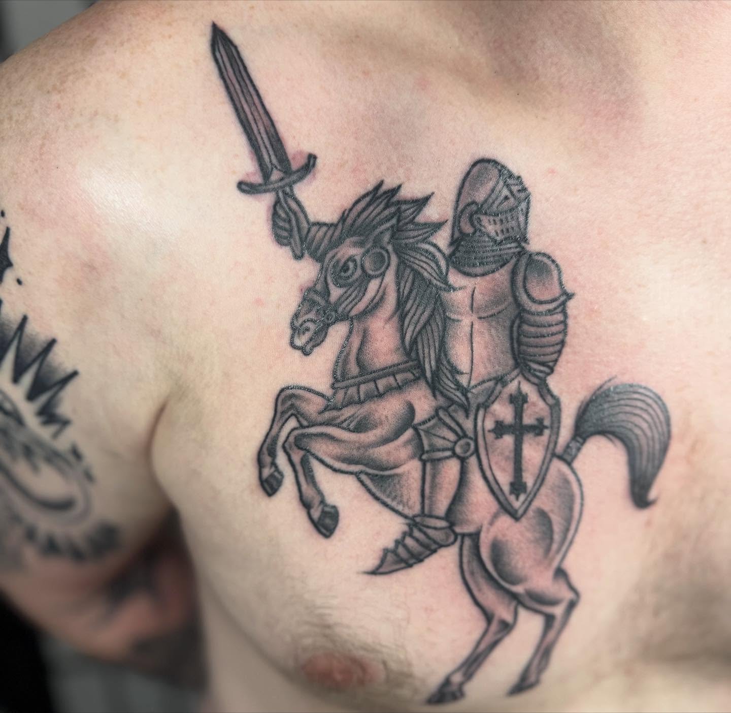 Knight on horseback black and grey tattoo on the chest by Justina🪐