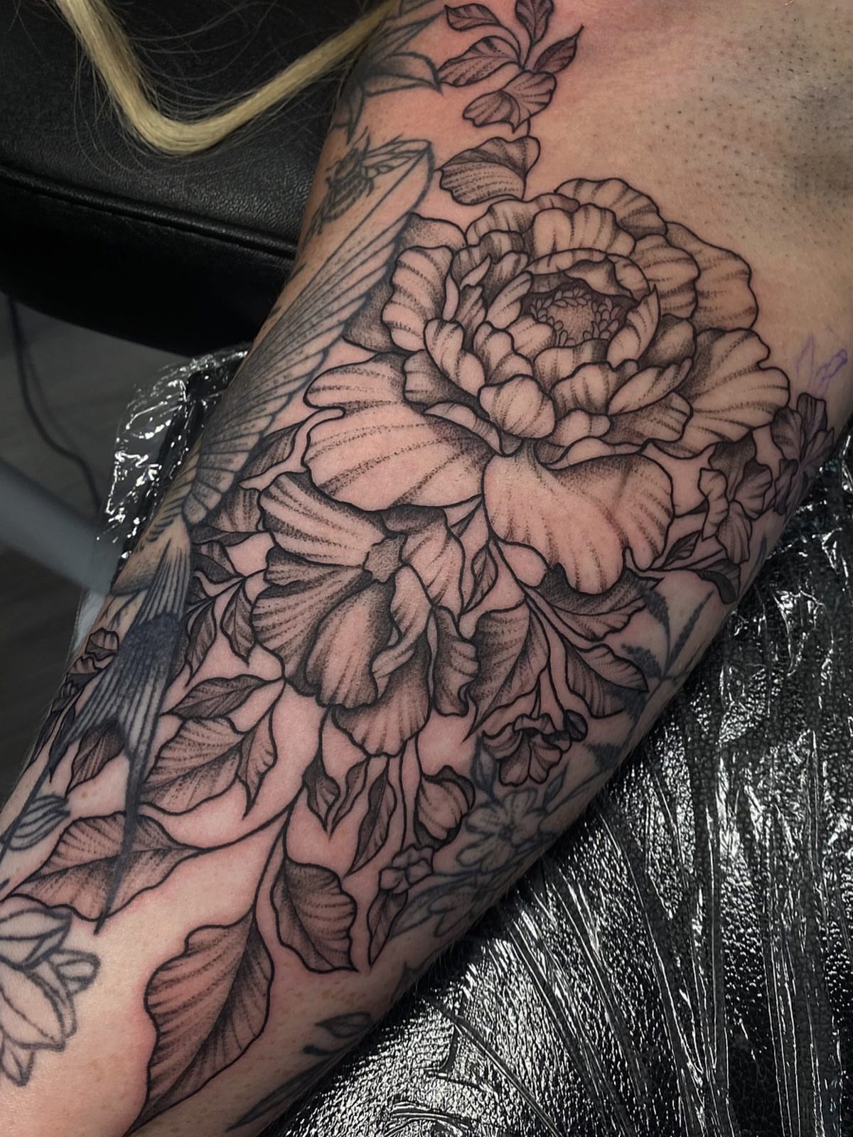 Peony black and grey tattoo on the forearm by Maddie Neibert