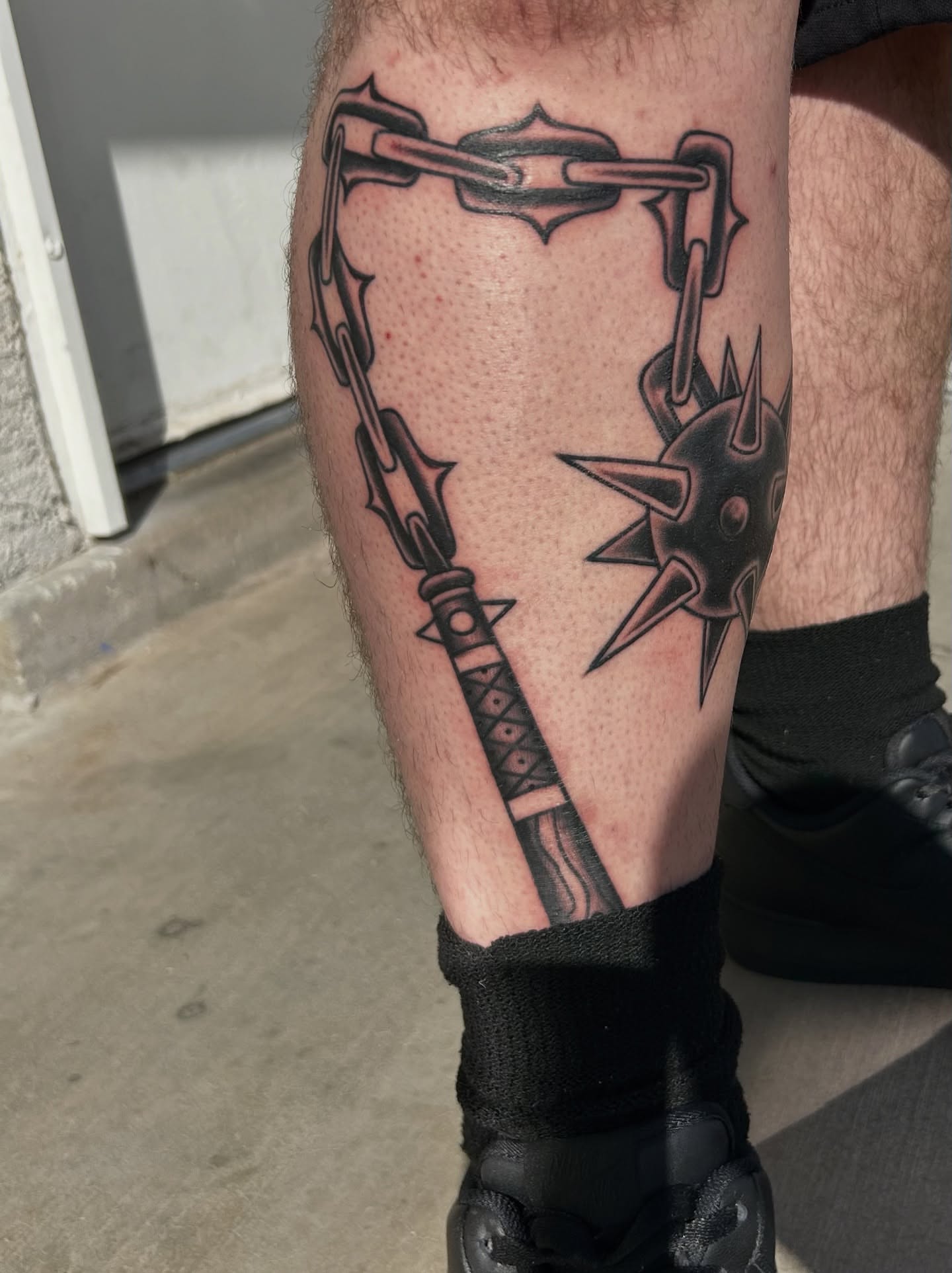 Chain and spike black and grey tattoo on the calf by Tattoos by Corey aka MrLu