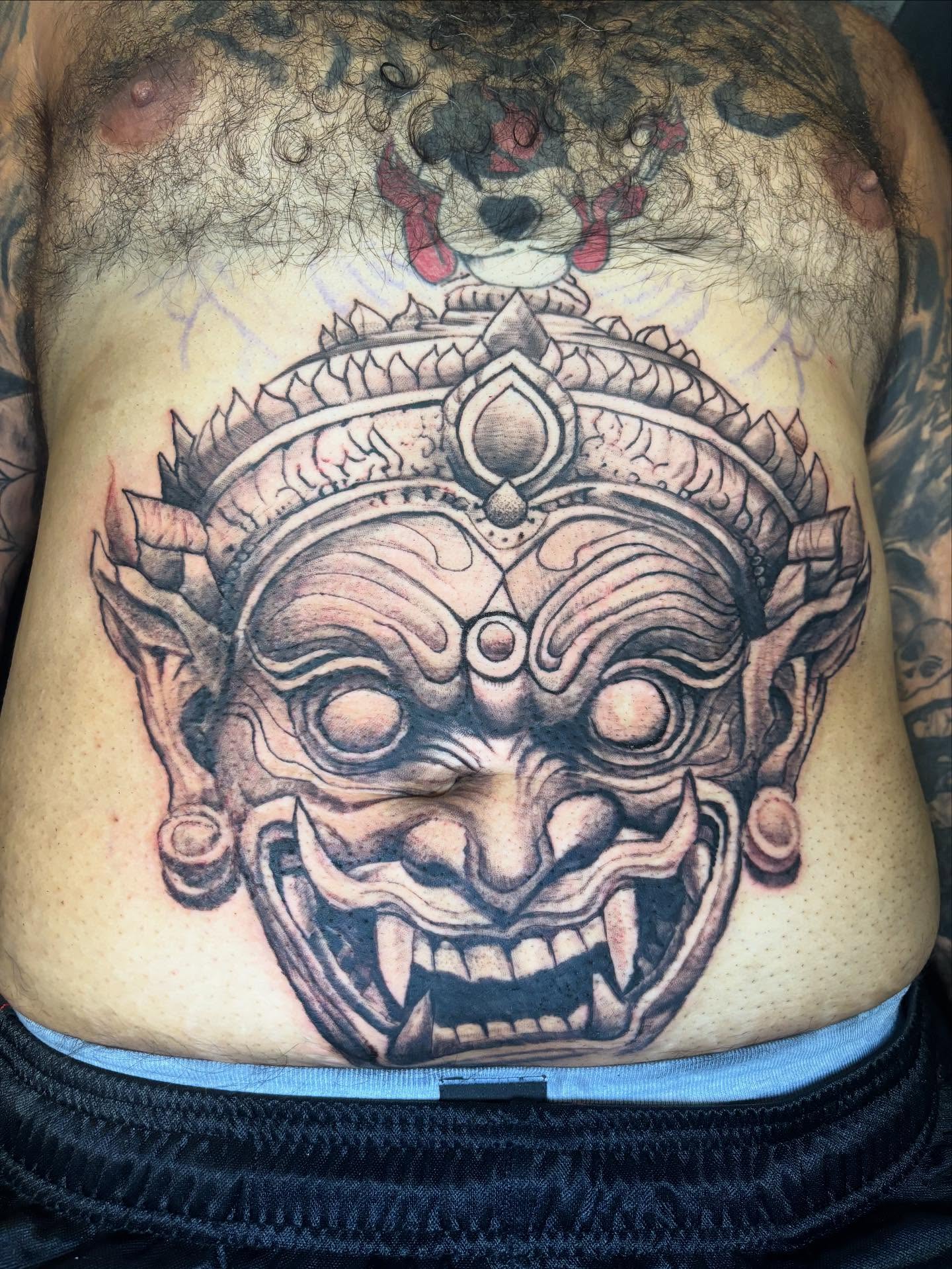 Demon mask realism tattoo on the chest by Dre Ortiz
