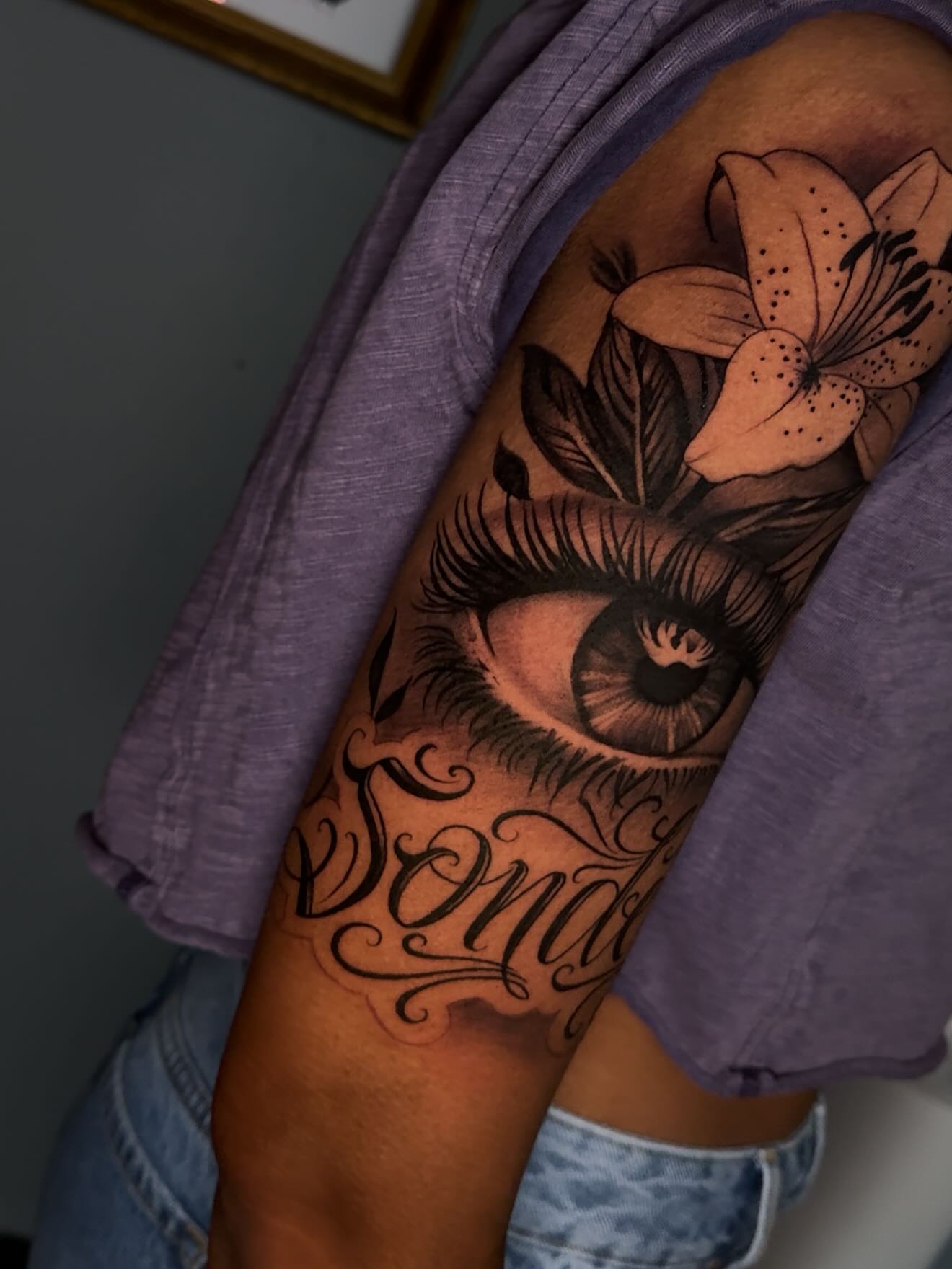 Eye and lily realism tattoo on the forearm by Smuk One