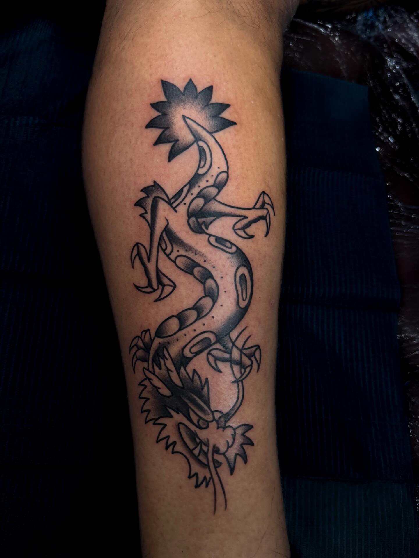 Dragon black and grey tattoo on the forearm by Demi DiMartino