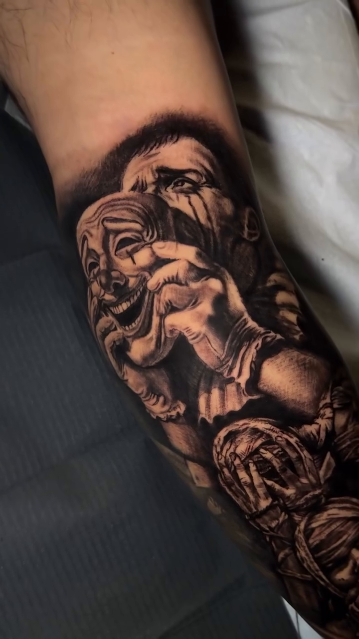 Comedy and tragedy masks with figures realism tattoo by Gary Graves