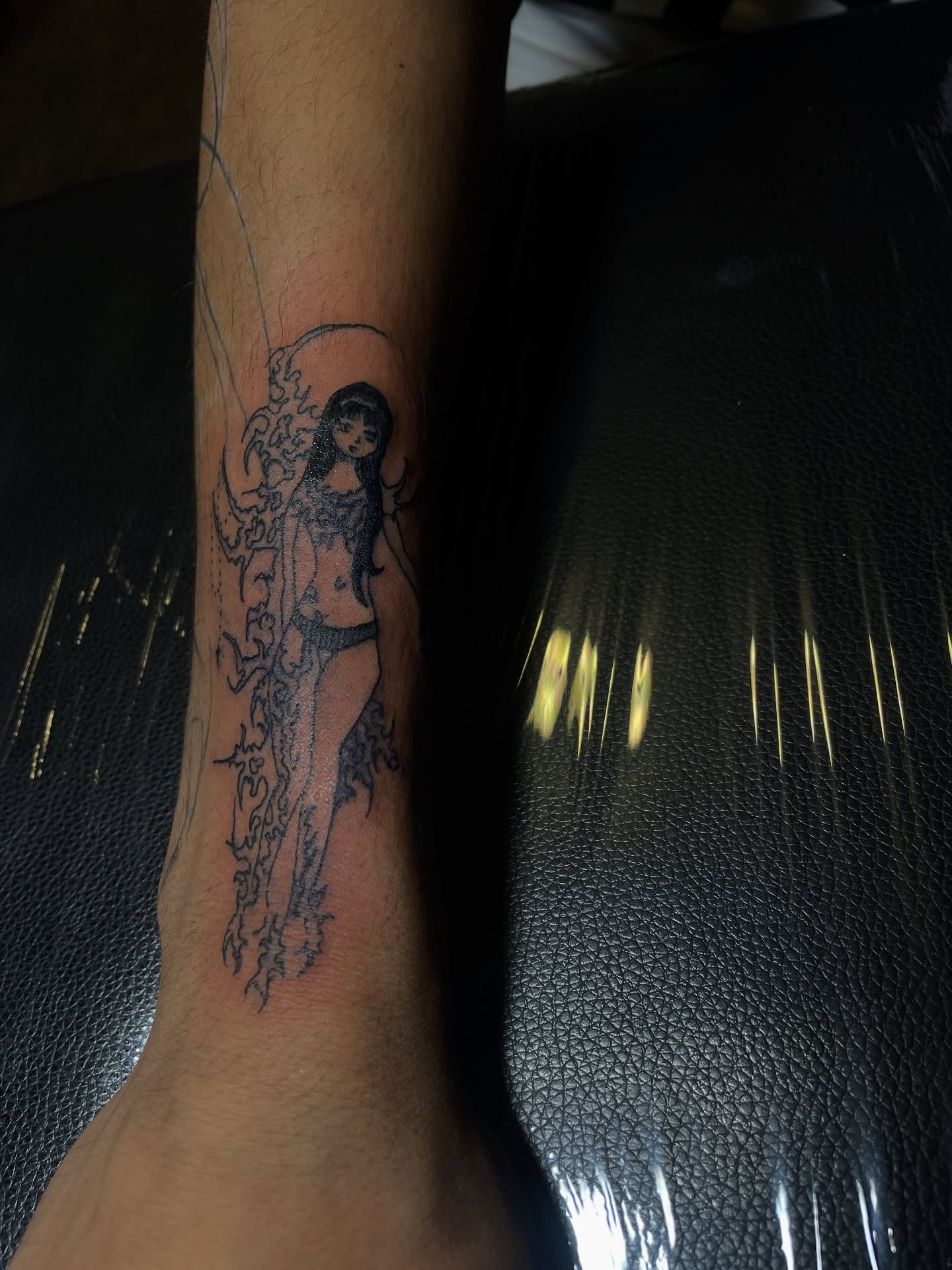 Woman with flames black and grey tattoo on the forearm by ɴᴏᴍᴢ ᴅʏsᴇᴍʙᴏᴅɪᴍᴇɴᴛ