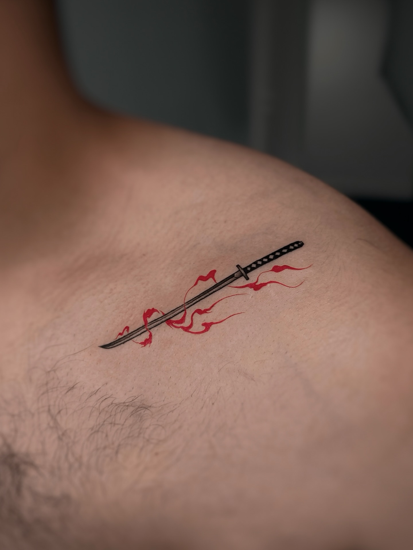 Katana with flames dotwork tattoo on the shoulder by Lily K.