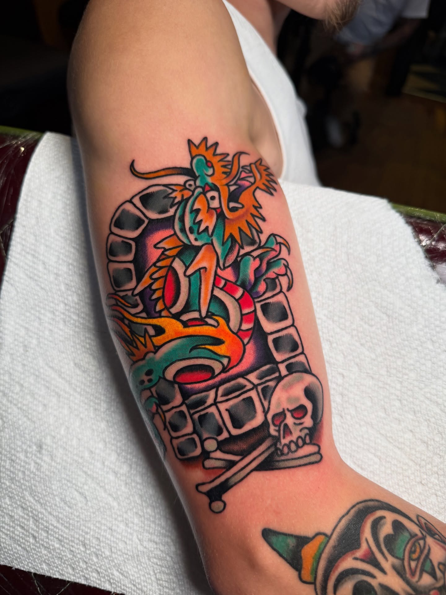 Dragon and skull American traditional tattoo on the forearm by πππ’π―π’π¨ πππΆπ©π¬π―π, Manchester, New Hampshire