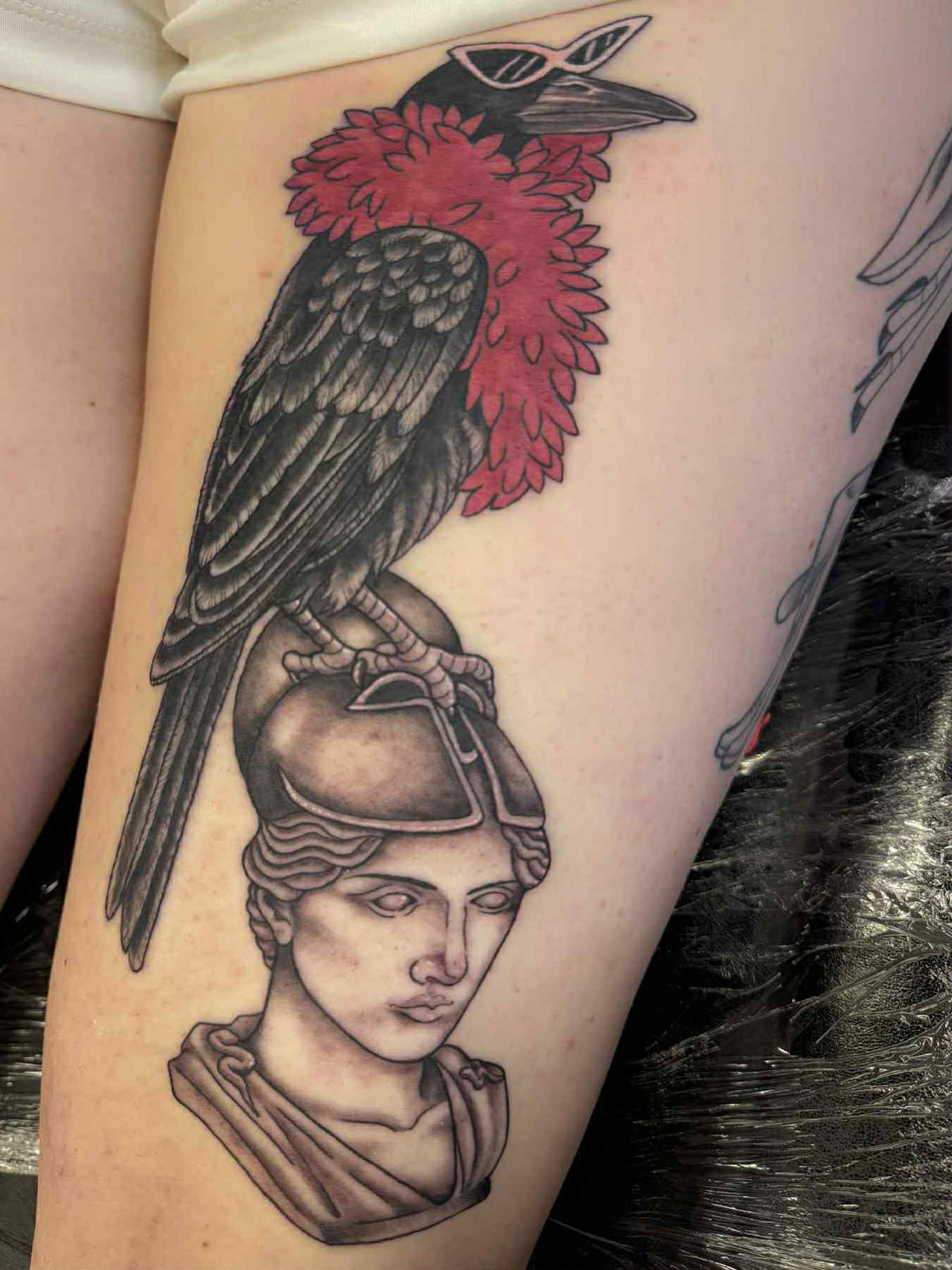 Raven and classical bust realism tattoo on the thigh by Erin Moore