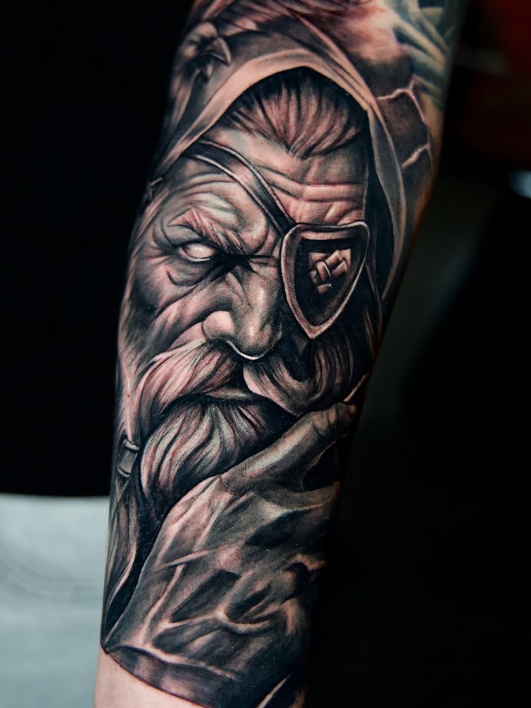 Old man with eye patch realism tattoo on the forearm by Luis Arenas