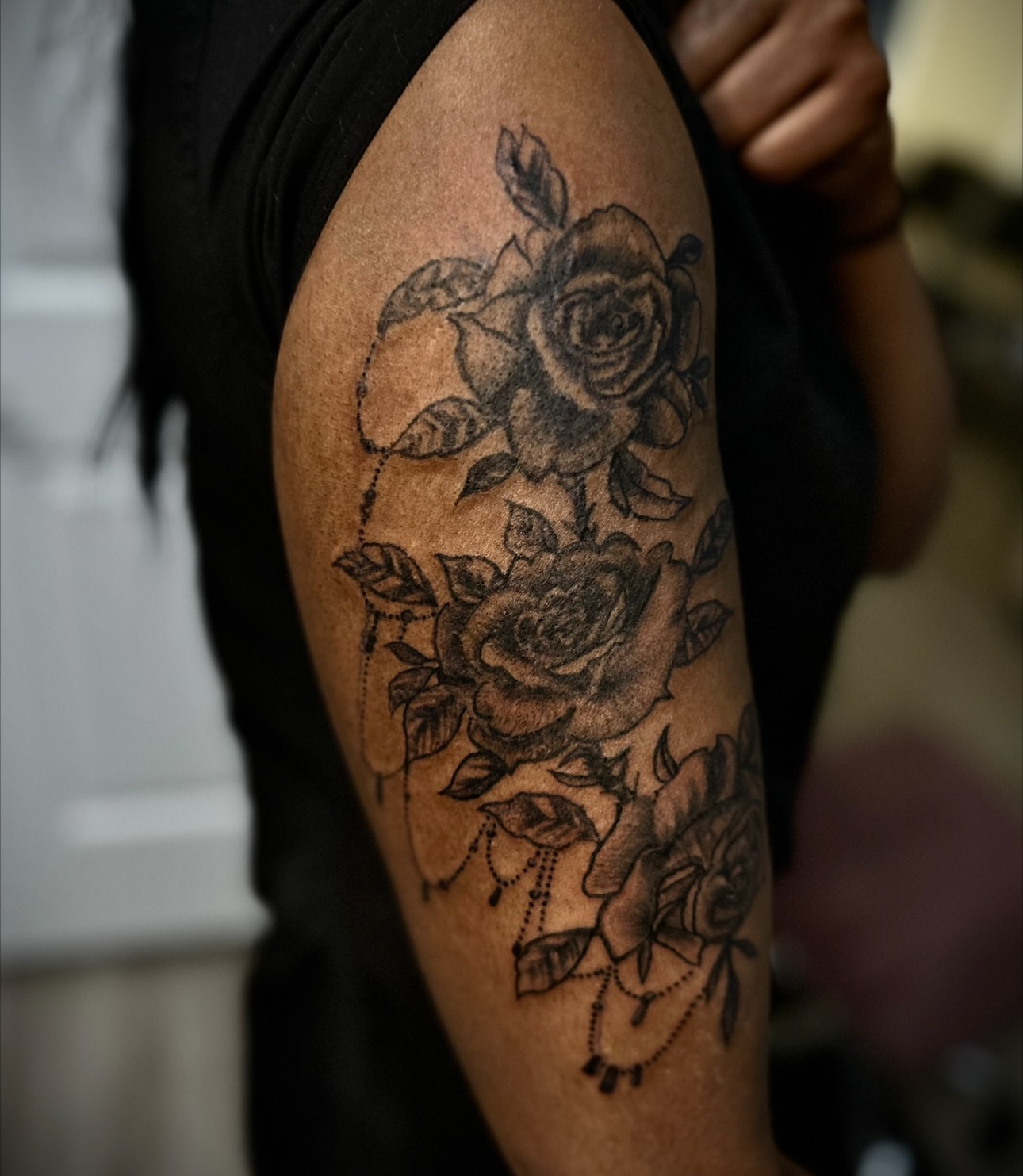 Roses black and grey tattoo on the upper arm by Ink’d by Reina 🖤, Colorado Springs, Colorado