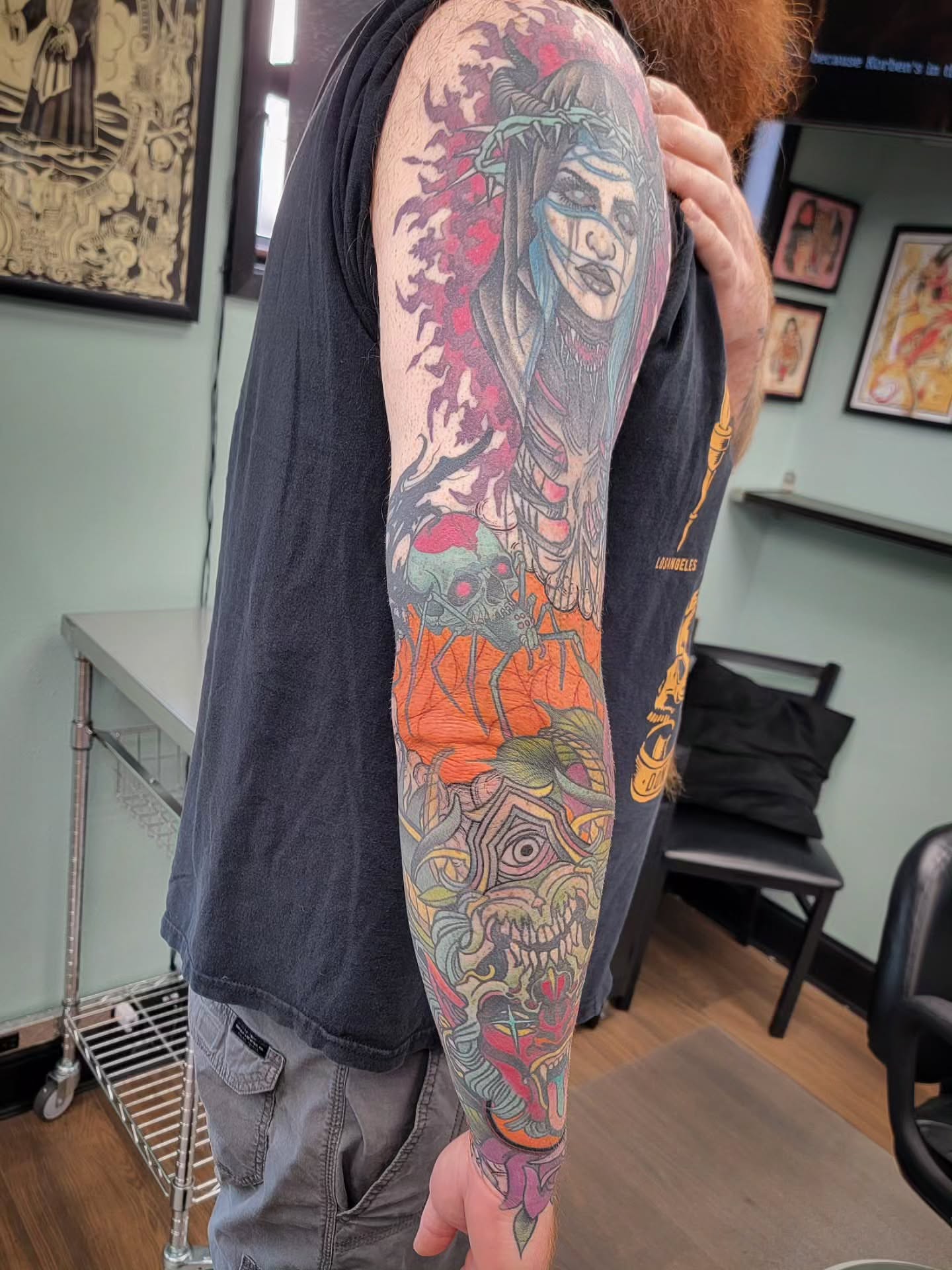 Woman with skull neo-traditional tattoo on the upper arm by Chantel Chan, Portland, Oregon