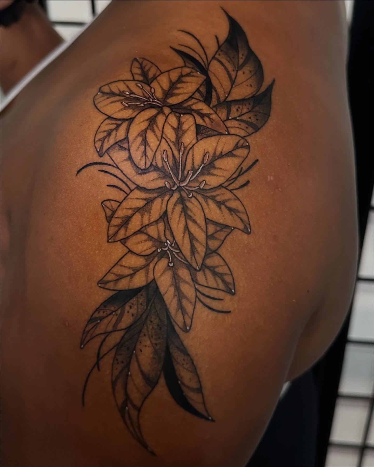 Lilies black and grey tattoo on the shoulder by Taylin Johnson- Illustrative Blackwork, Columbus, Ohio