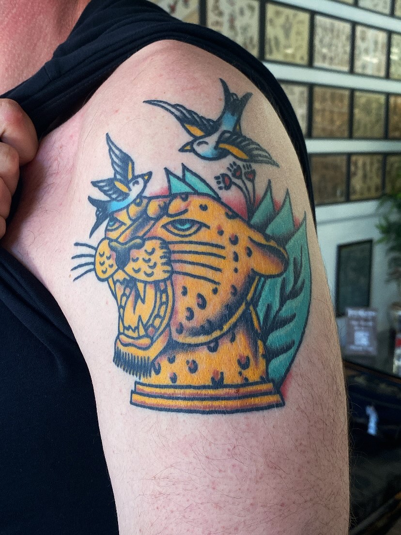 Cheetah and birds American traditional tattoo on the shoulder by @rubber_band_dan, San Francisco, California