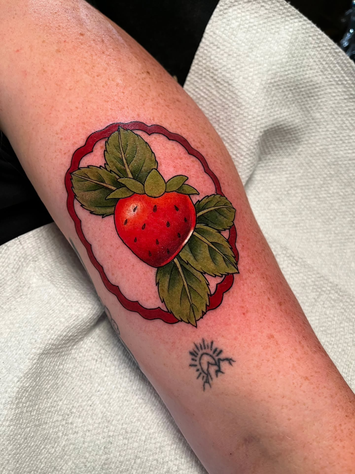 Strawberry realism tattoo on the forearm by Summer Machelle, Orange, California