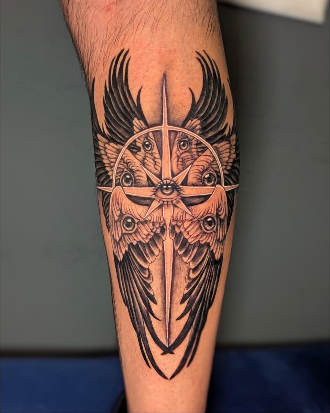 Compass with wings geometric tattoo on the forearm by Bethany Jane Tattoos