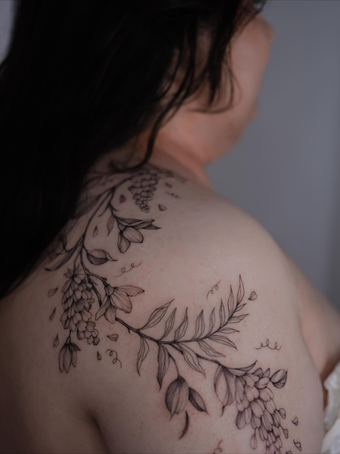 Wisteria and leaves black and grey tattoo on the shoulder by Tattoo artist in Boston