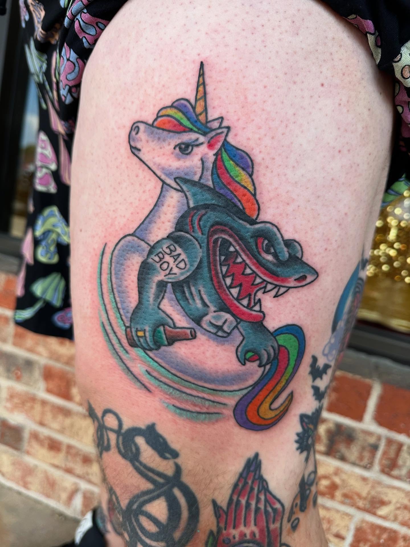 Unicorn and dragon new school tattoo on the thigh by Whitney Creep Tattoos