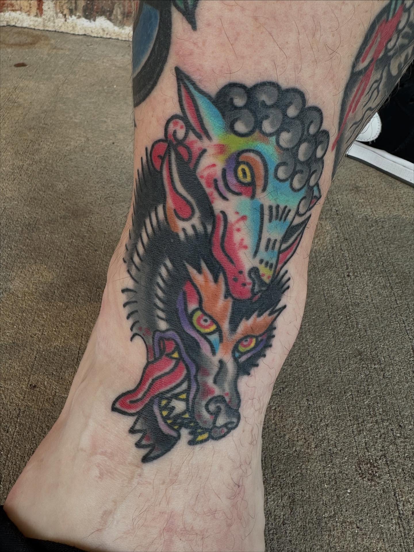 Wolf American traditional tattoo on the leg by Whitney Creep Tattoos