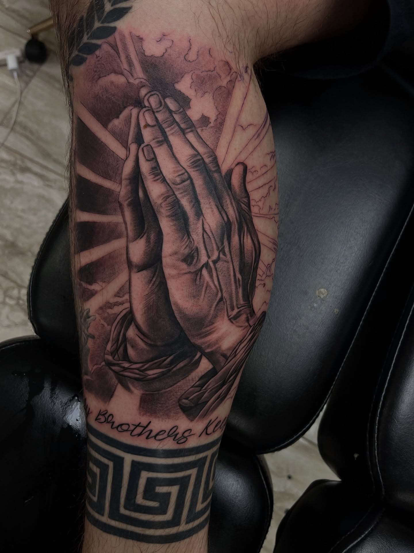Praying hands realism tattoo on the forearm by Quinten Harper