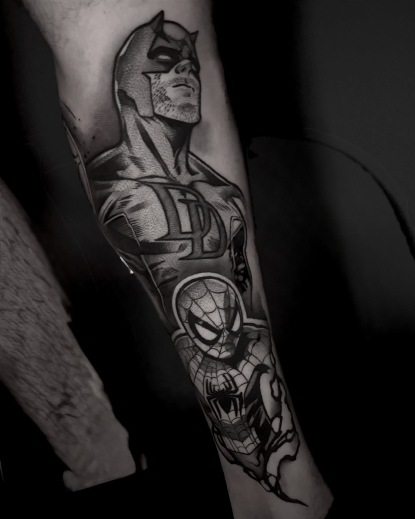 Superhero characters black and grey tattoo on the forearm by Clayton Smith (BEAR)
