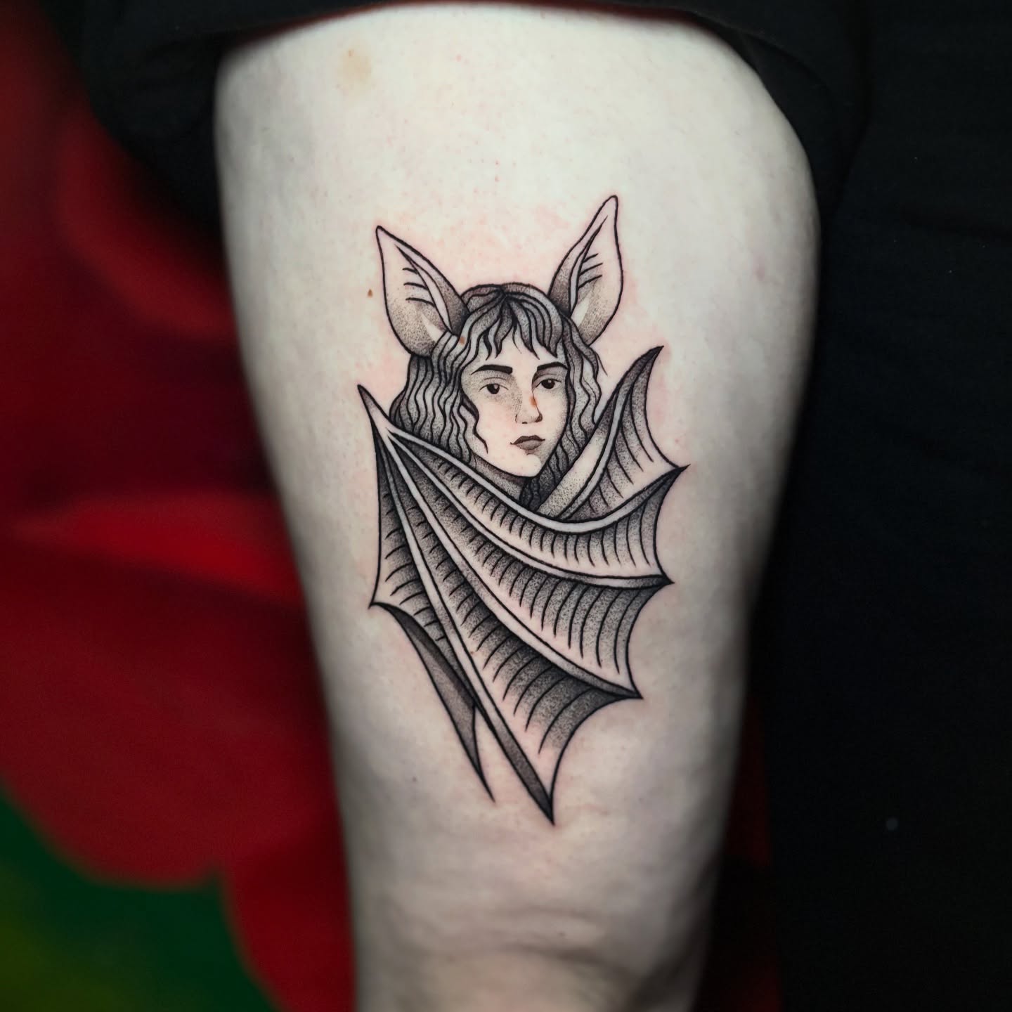 Elf-like figure black and grey tattoo on the thigh by 𝕊𝕒𝕞 ☪︎ ִ ࣪𖤐 𐦍 ☾𖤓