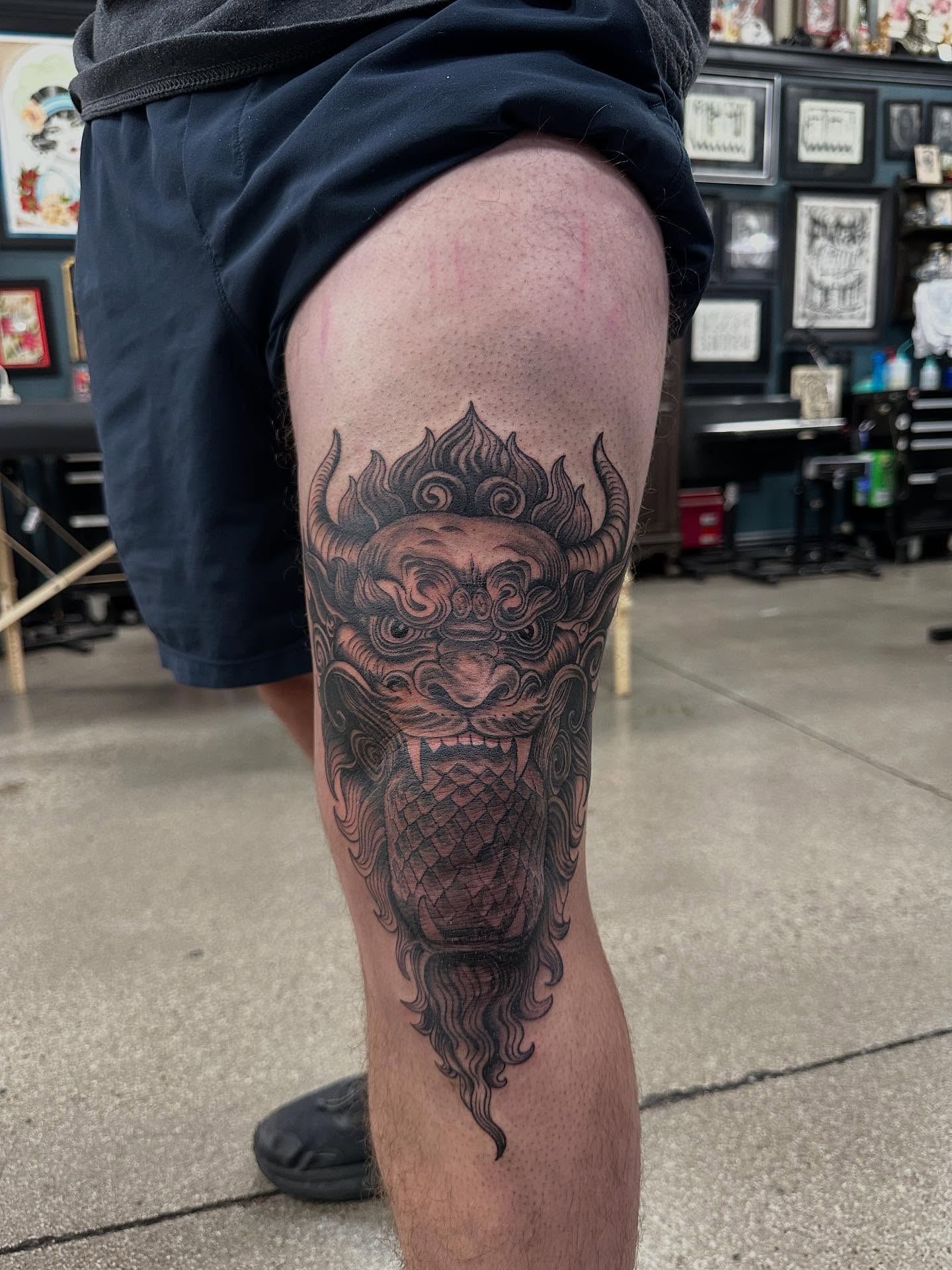Lion black and grey tattoo on the thigh by Shawn Feng