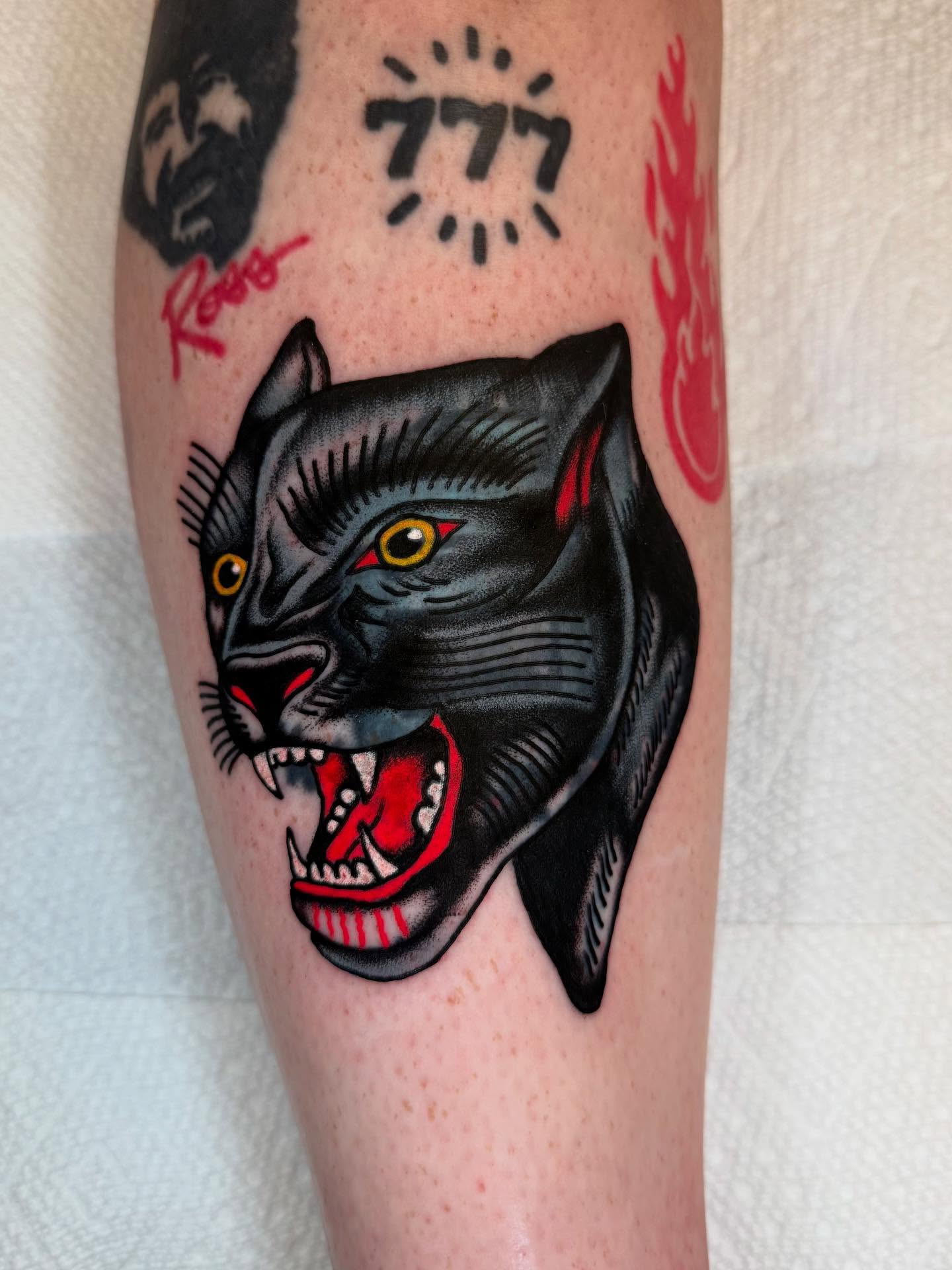 Panther head American traditional tattoo on the forearm by Cody Petkus