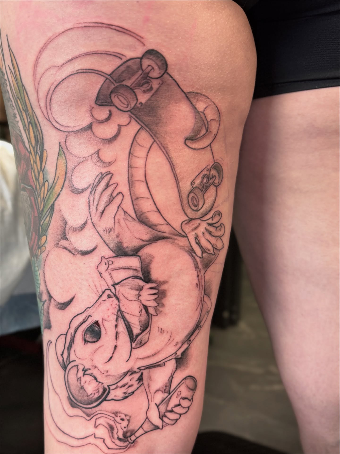 Skateboarder realism tattoo on the thigh by Joe Hall