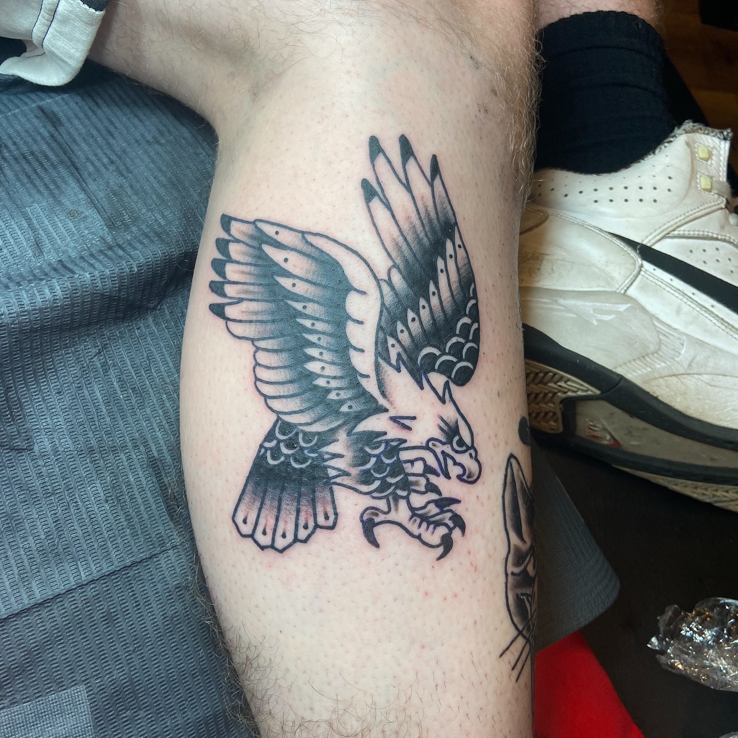 Eagle black and grey tattoo on the thigh by Anthony Robles
