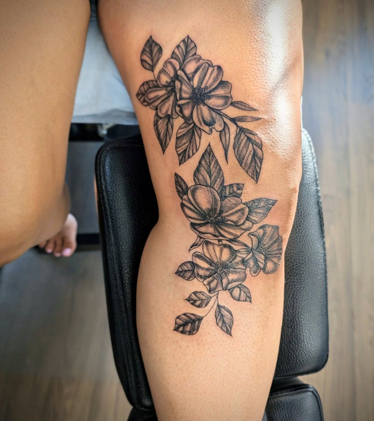 Flowers black and grey tattoo on the thigh by Devon Ward, Portland, Oregon