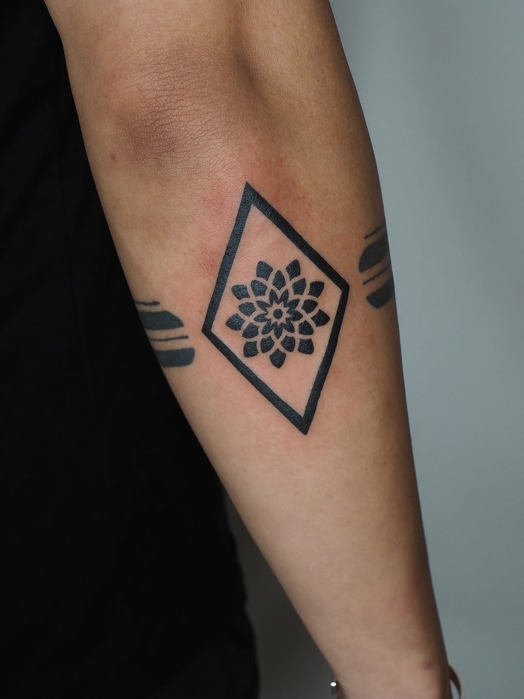 Geometric flower in diamond geometric tattoo on the forearm by A. Eye Tat