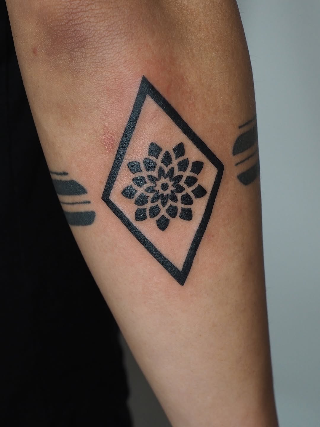 Geometric mandala in diamond geometric tattoo on the forearm by A. Eye Tat