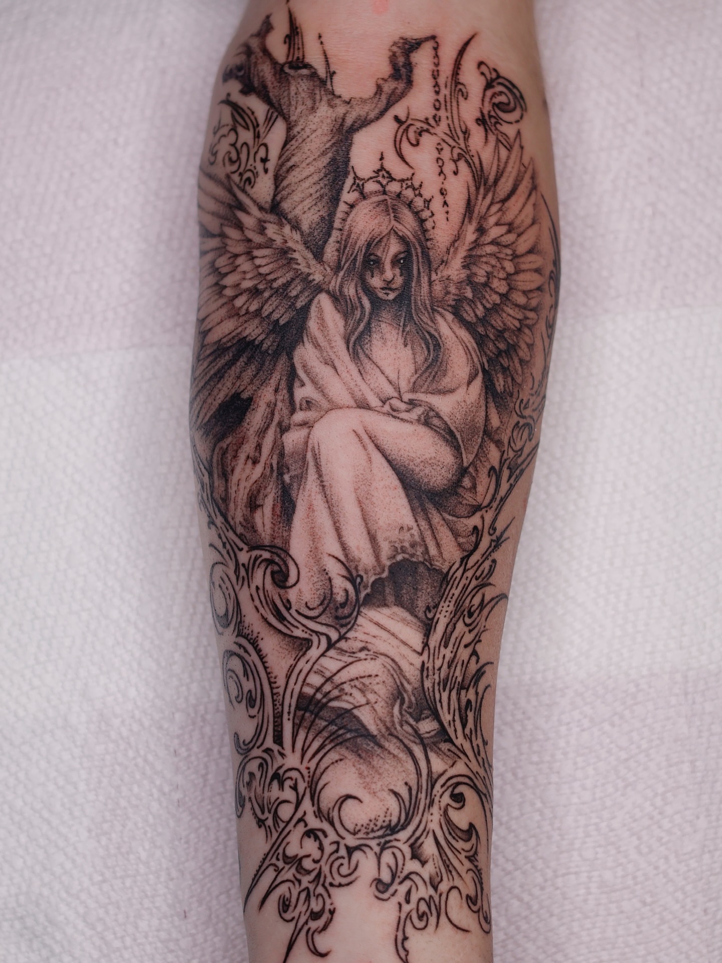 Angel realism tattoo on the forearm by Júlia Sorrino