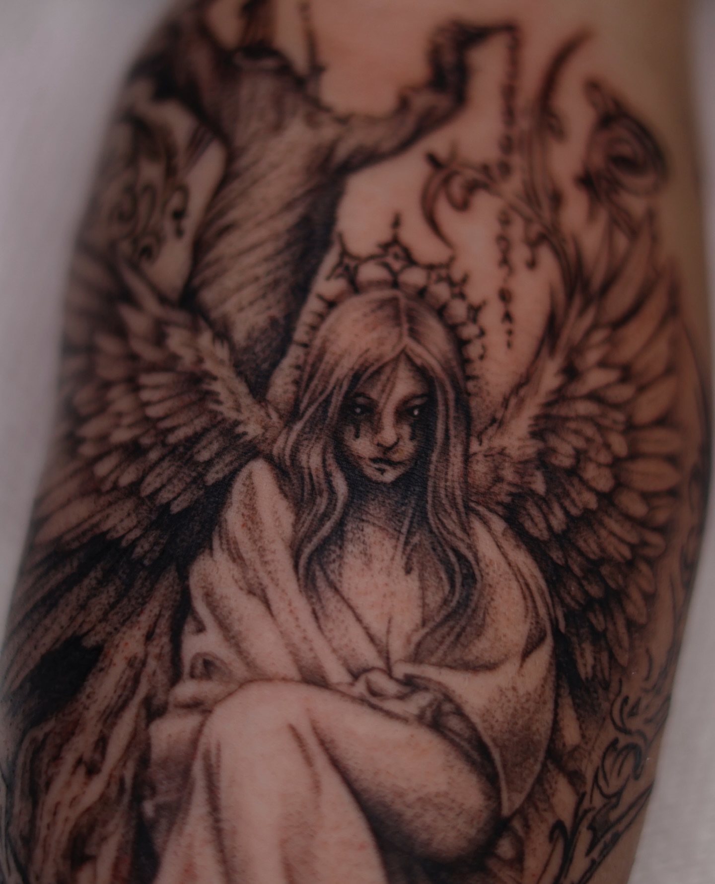 Angel black and grey tattoo on the forearm by Júlia Sorrino