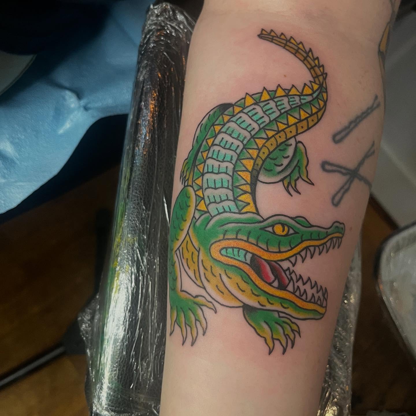 Alligator American traditional tattoo on the forearm by Mariah Nguyen
