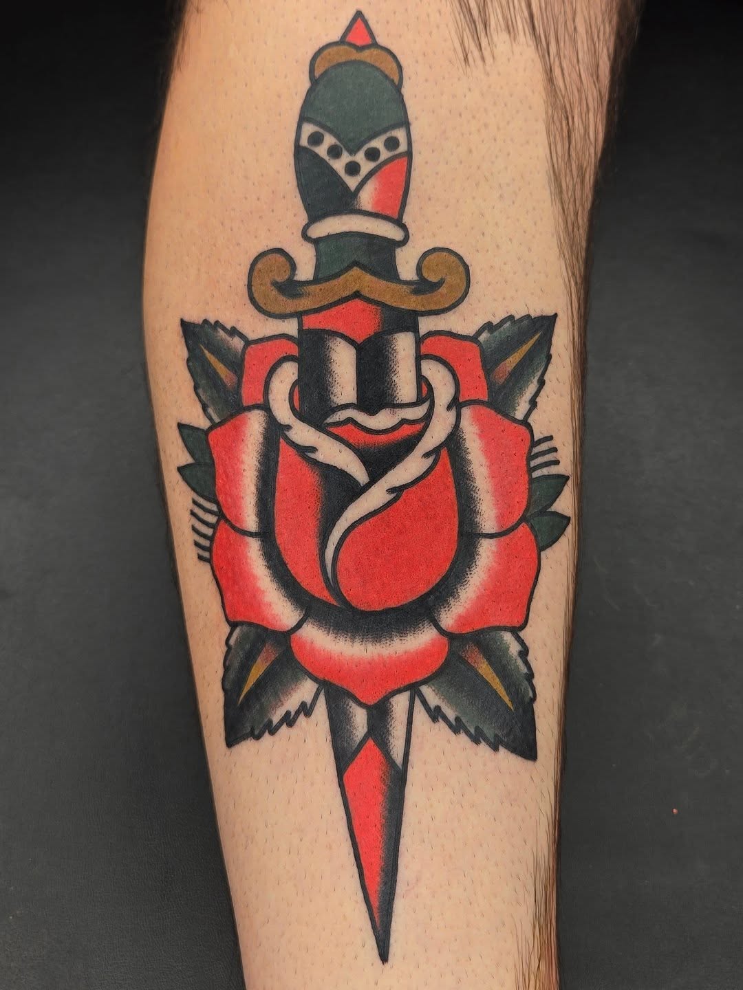 Rose and dagger American traditional tattoo on the forearm by Deke Harms, Bend, Oregon