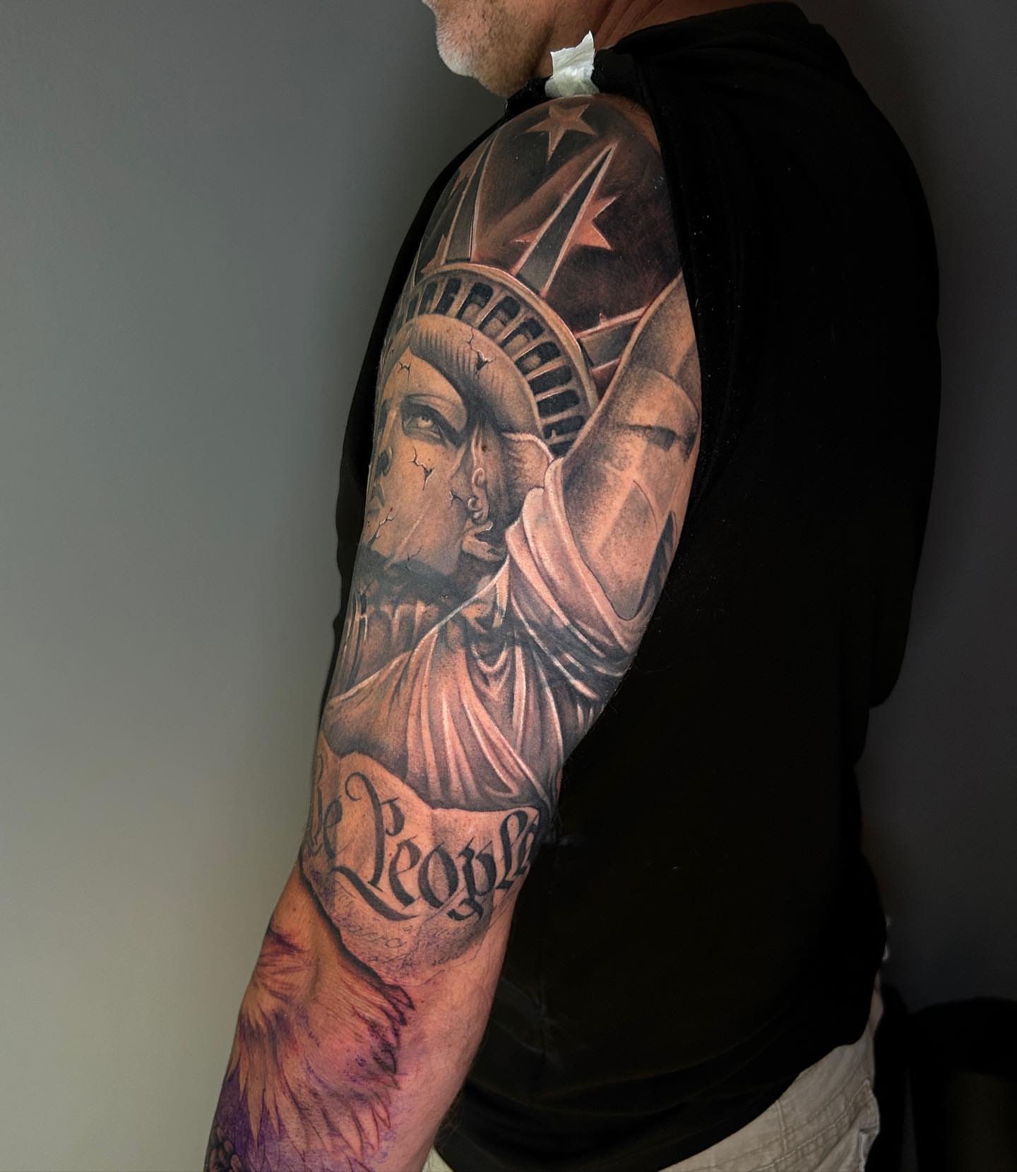 Statue of liberty realism tattoo on the upper arm by Taylor Steckman