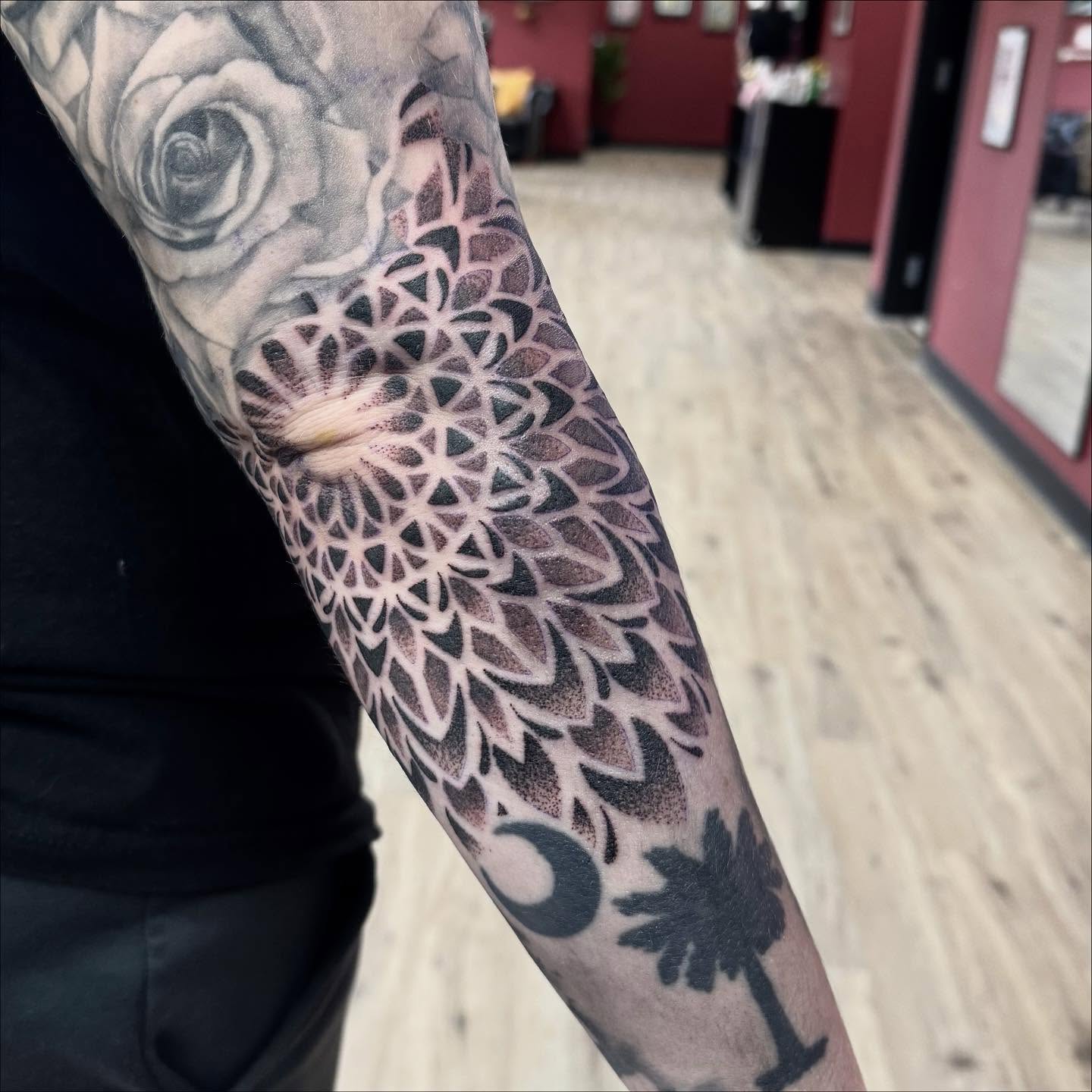 Geometric mandala dotwork tattoo on the forearm by Robbie Bryant