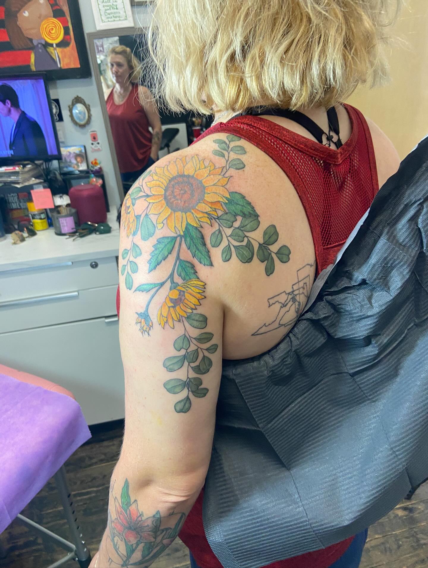 Sunflower and leaves new school tattoo on the shoulder by Dont Worry About It