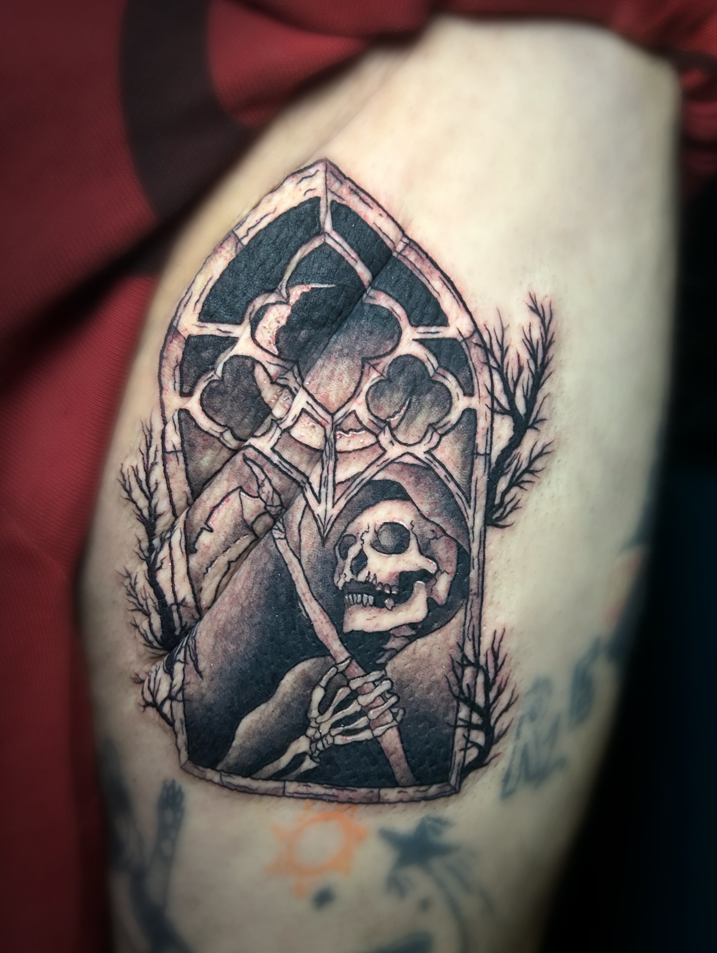 Stained glass window with skeleton realism tattoo on the thigh by Vanessa Kendyll’s Tattoos