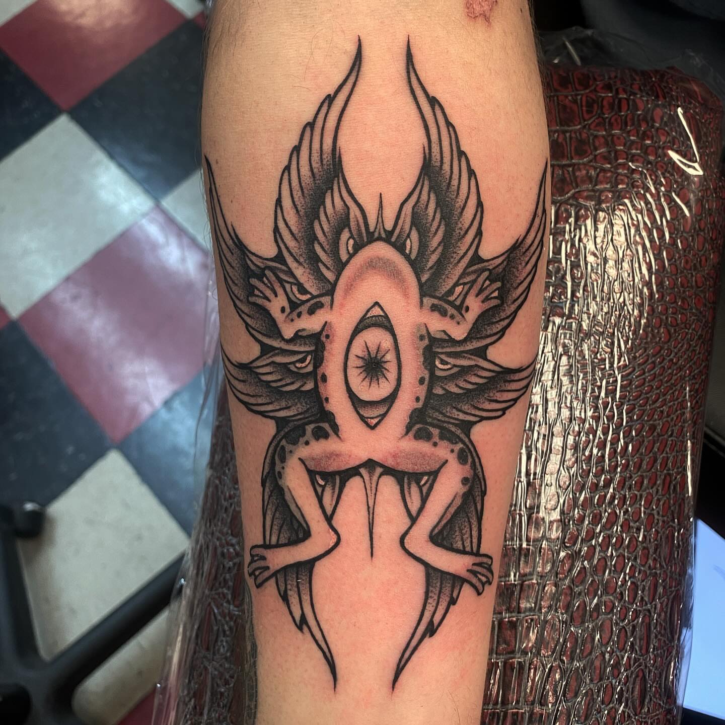 Eye with wings dotwork tattoo on the forearm by Jonah