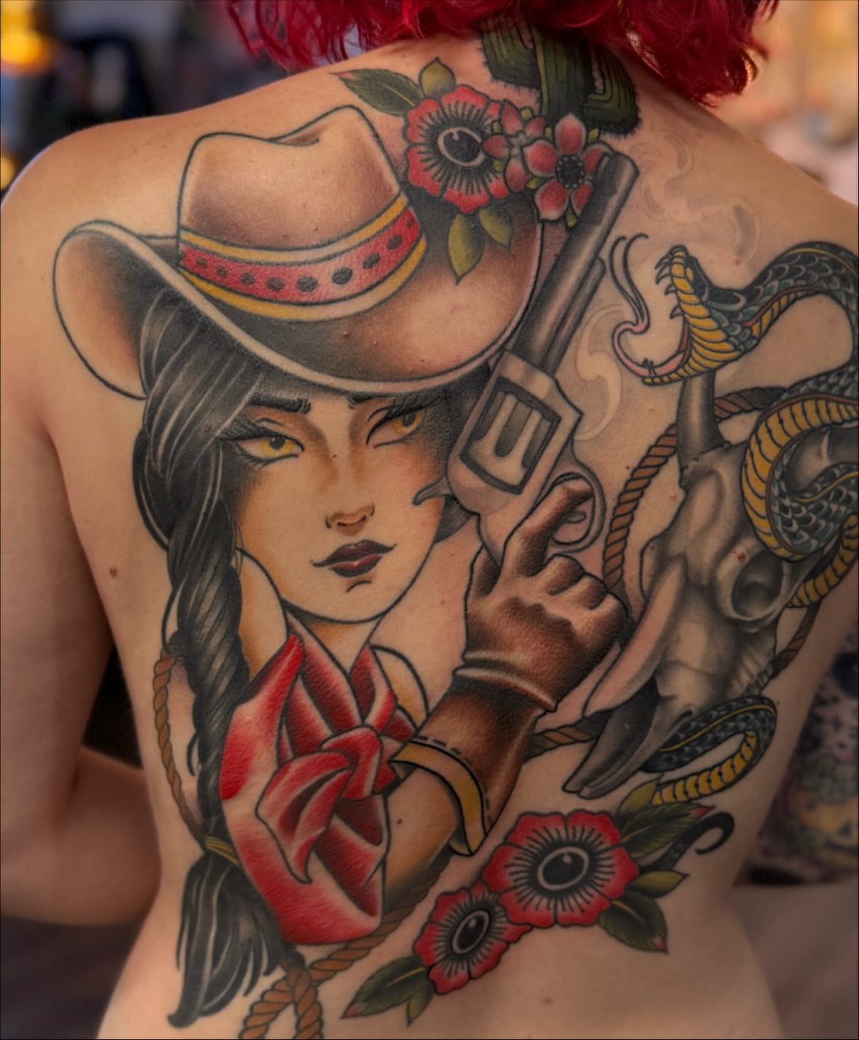 Cowgirl with revolver American traditional tattoo on the back by Chase Martines