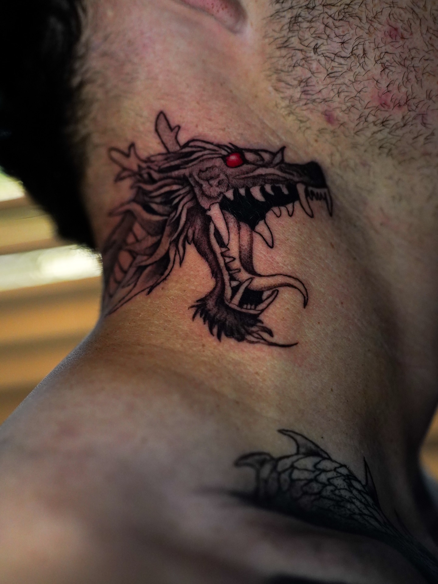Dragon black and grey tattoo on the neck by Dallas Tattoo Artist