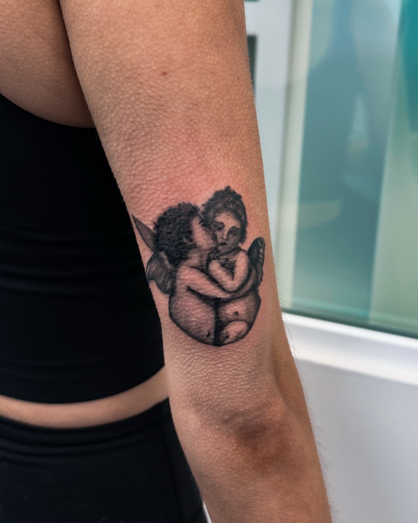 Angels black and grey tattoo on the forearm by utah tattoo artist