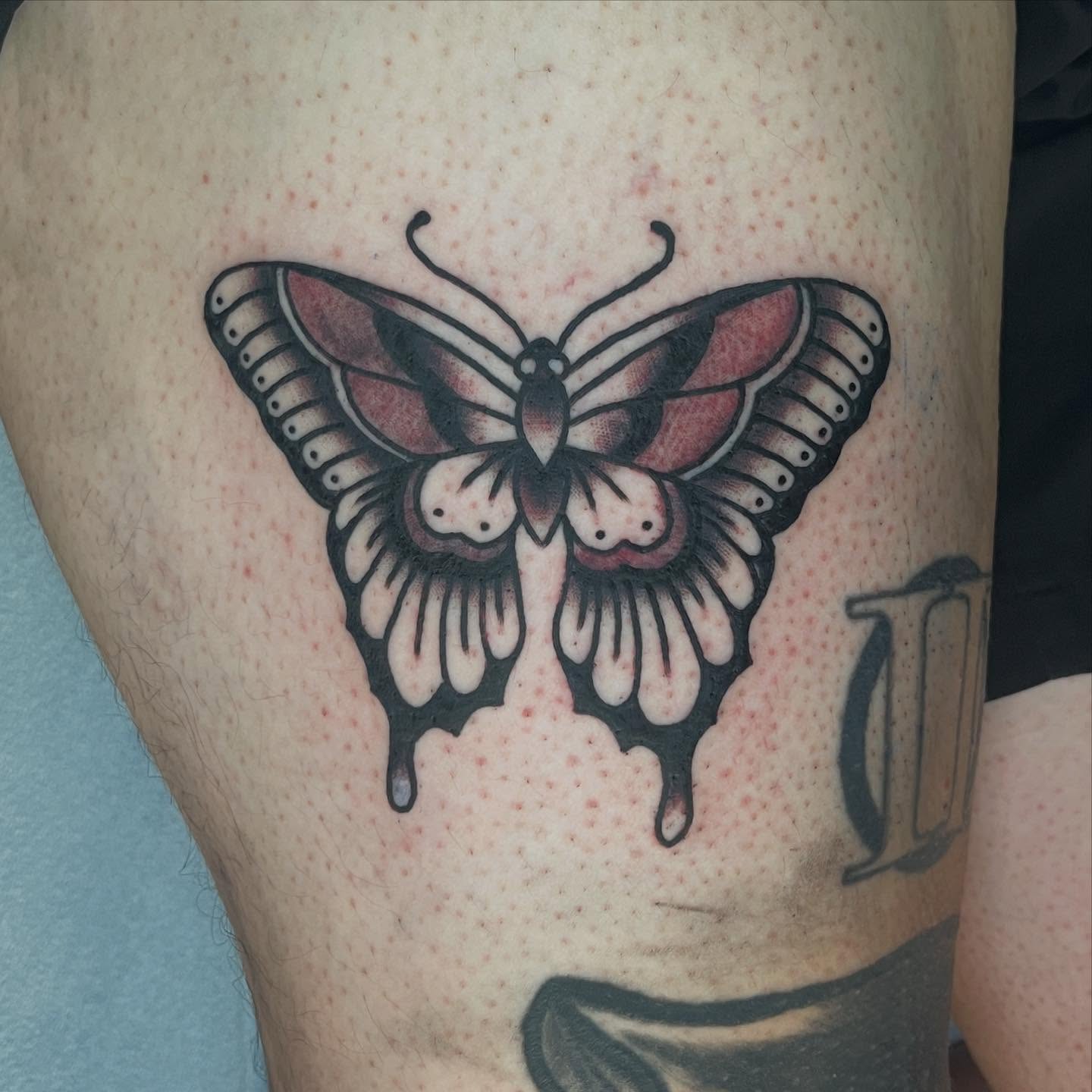 Butterfly American traditional tattoo on the thigh by Ryan Kim