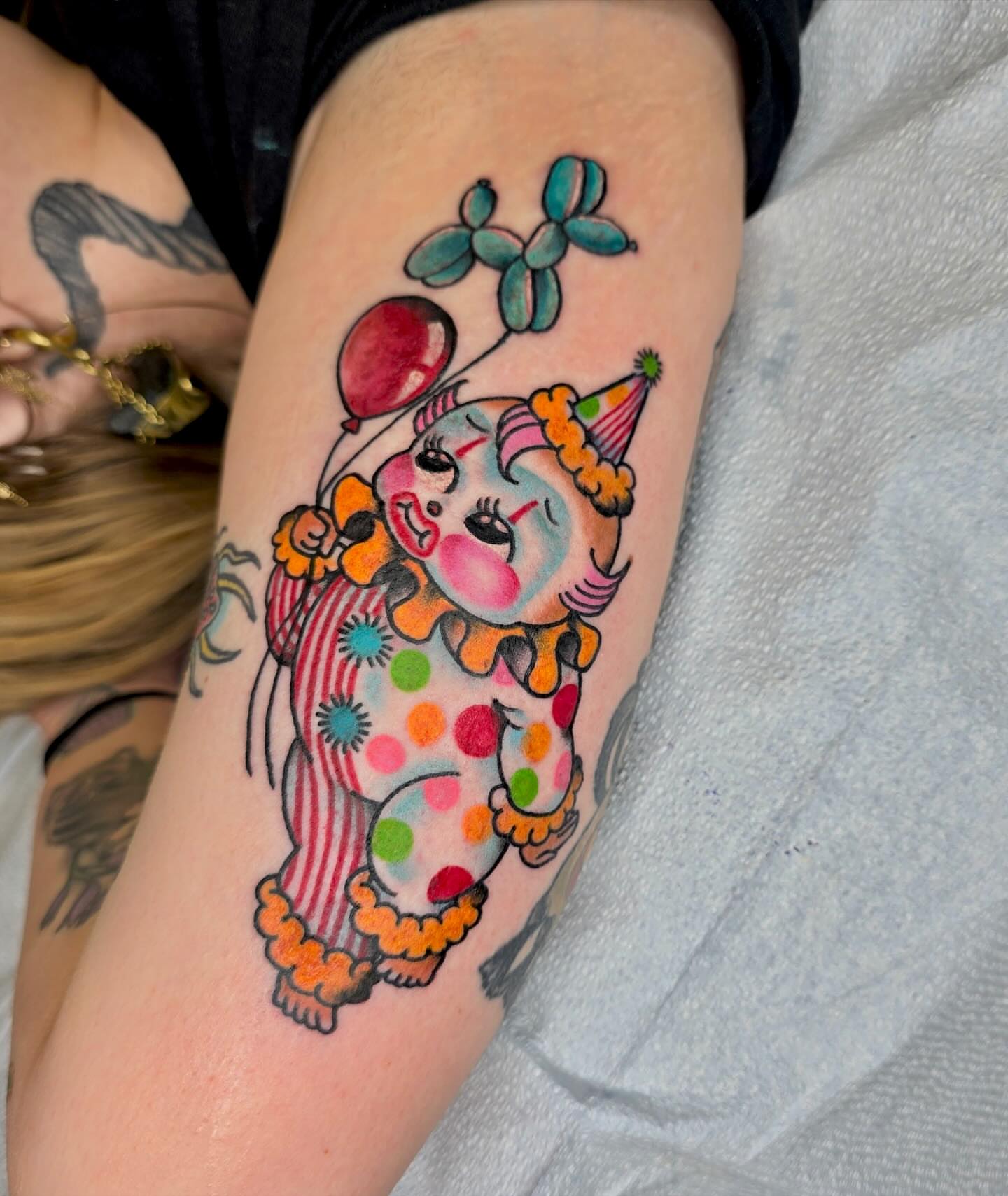 Clown balloon animal new school tattoo on the forearm by Mika Clairissa