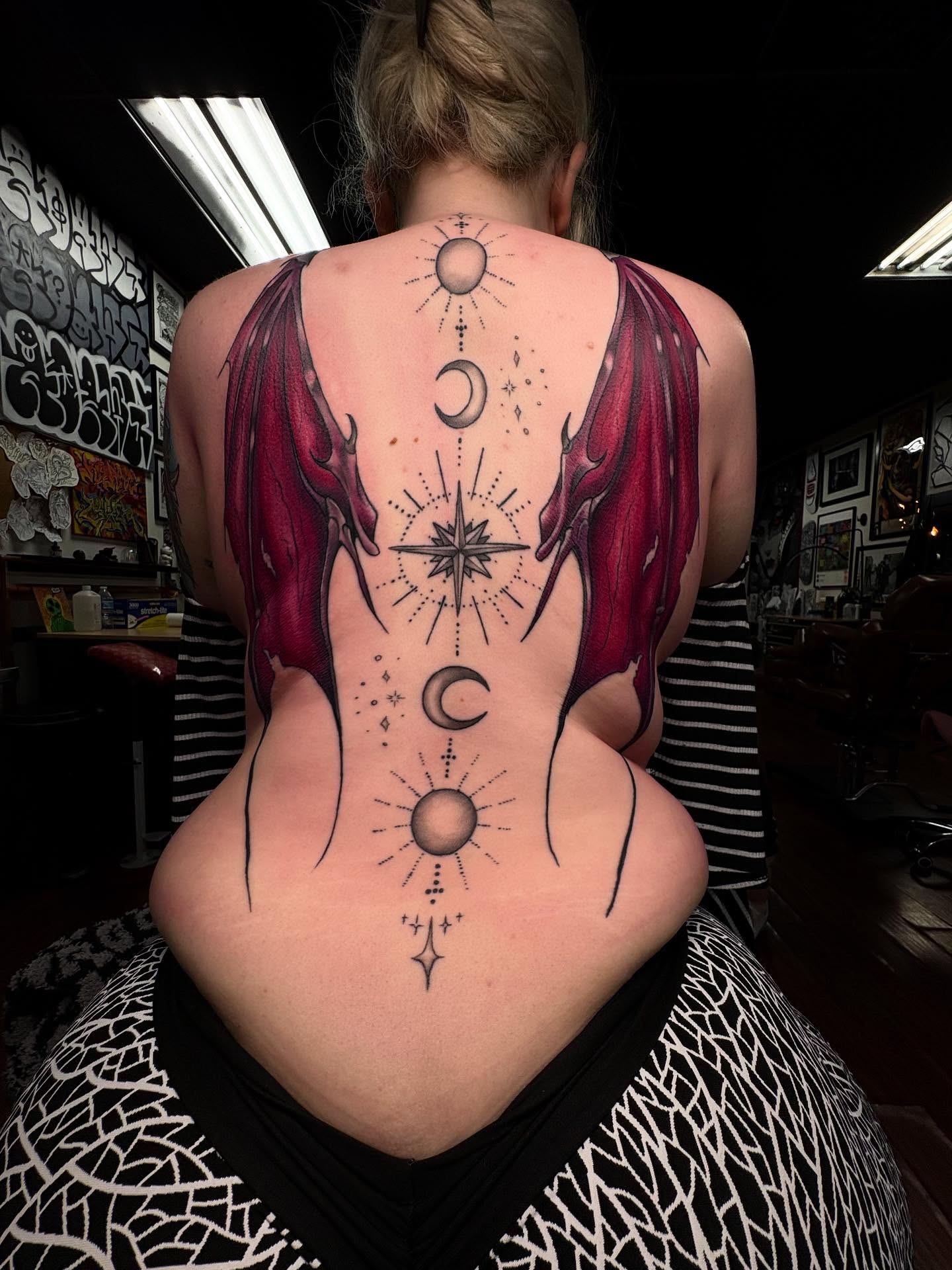 Astral symbols dotwork tattoo on the back by Alexandria