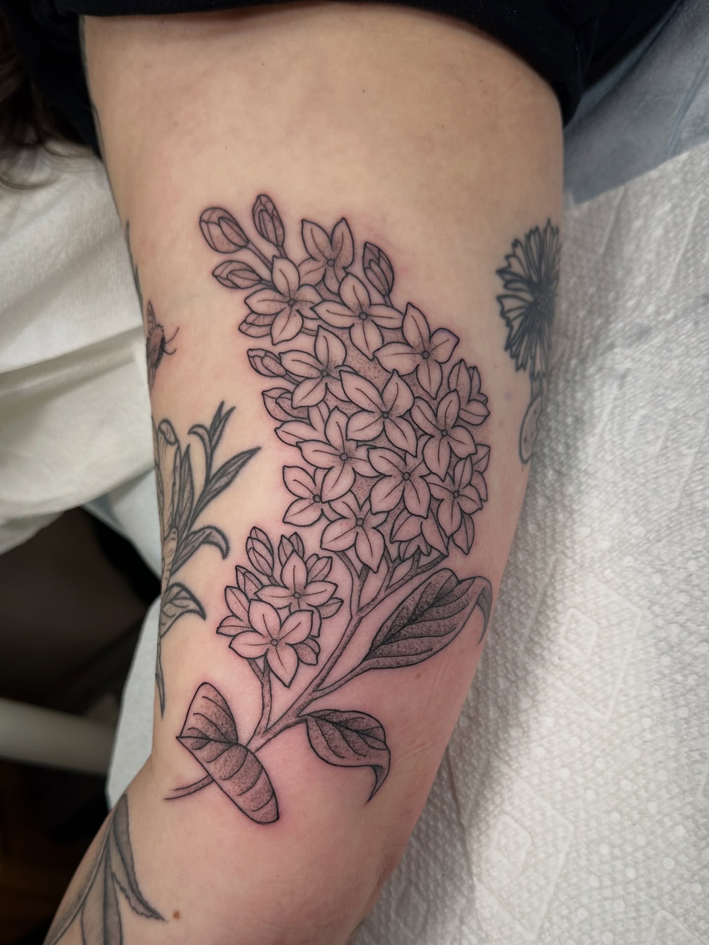 Flower bouquet black and grey tattoo on the forearm by Tattooing by Patty Valentine