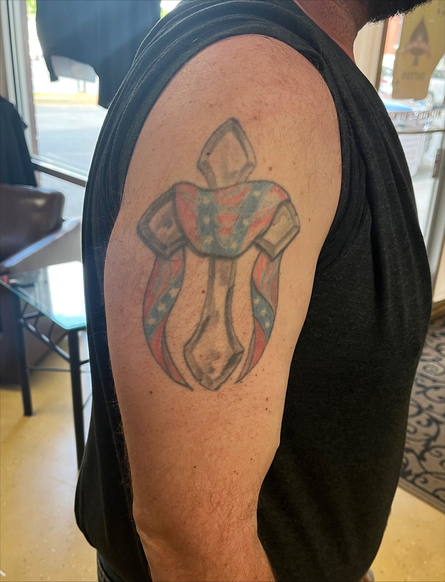 Hooded figure American traditional tattoo on the shoulder by Tabitha Mathis